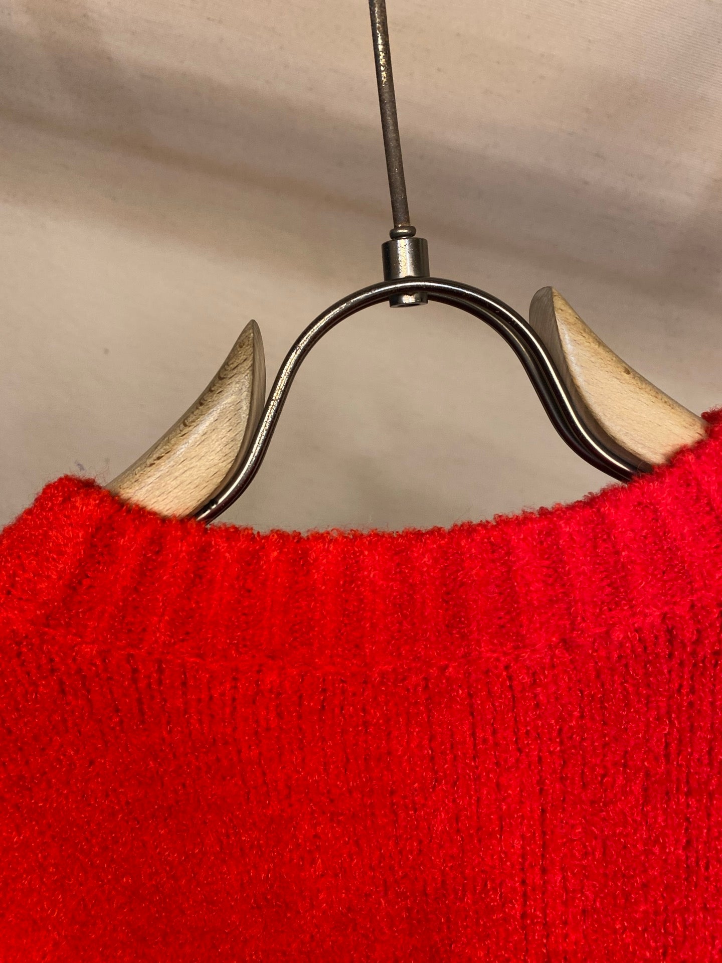 Red knit sweater back with ribbed neckline and hem