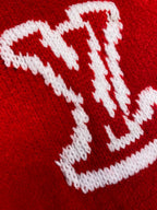 White Louis Vuitton monogram knit detail on red sweater