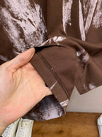 Louis Vuitton short-sleeve T-shirt sleeve hem close-up, dark brown with white splatter print