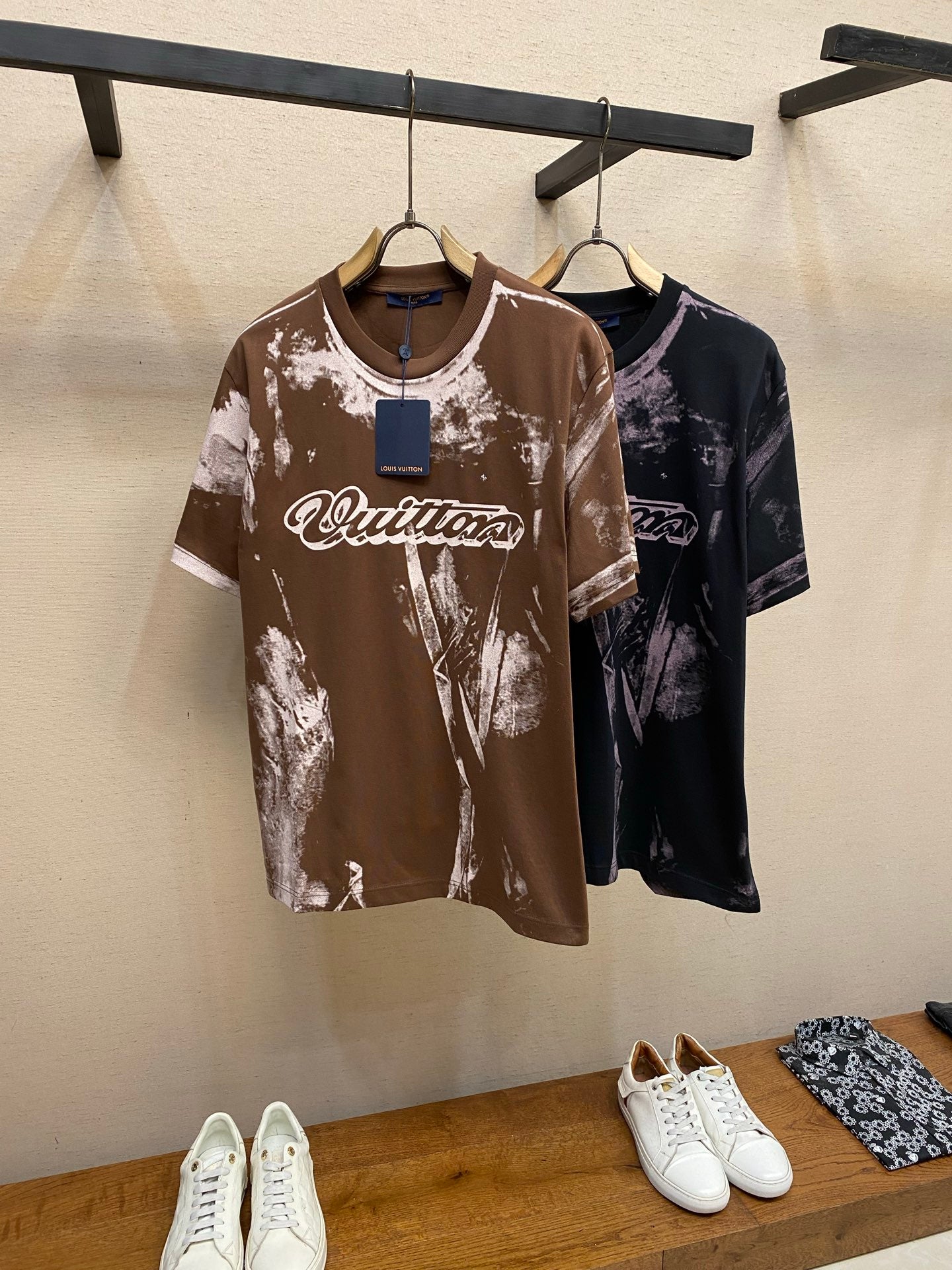 Two Louis Vuitton short-sleeve T-shirts: dark brown and dark navy, both with white splatter print