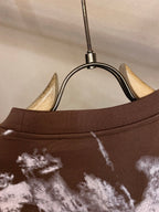 Louis Vuitton T-shirt collar close-up with white splatter print on dark brown