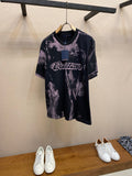 Louis Vuitton graphic T-shirt with dark base and purple splatter print, crew neck, short sleeves