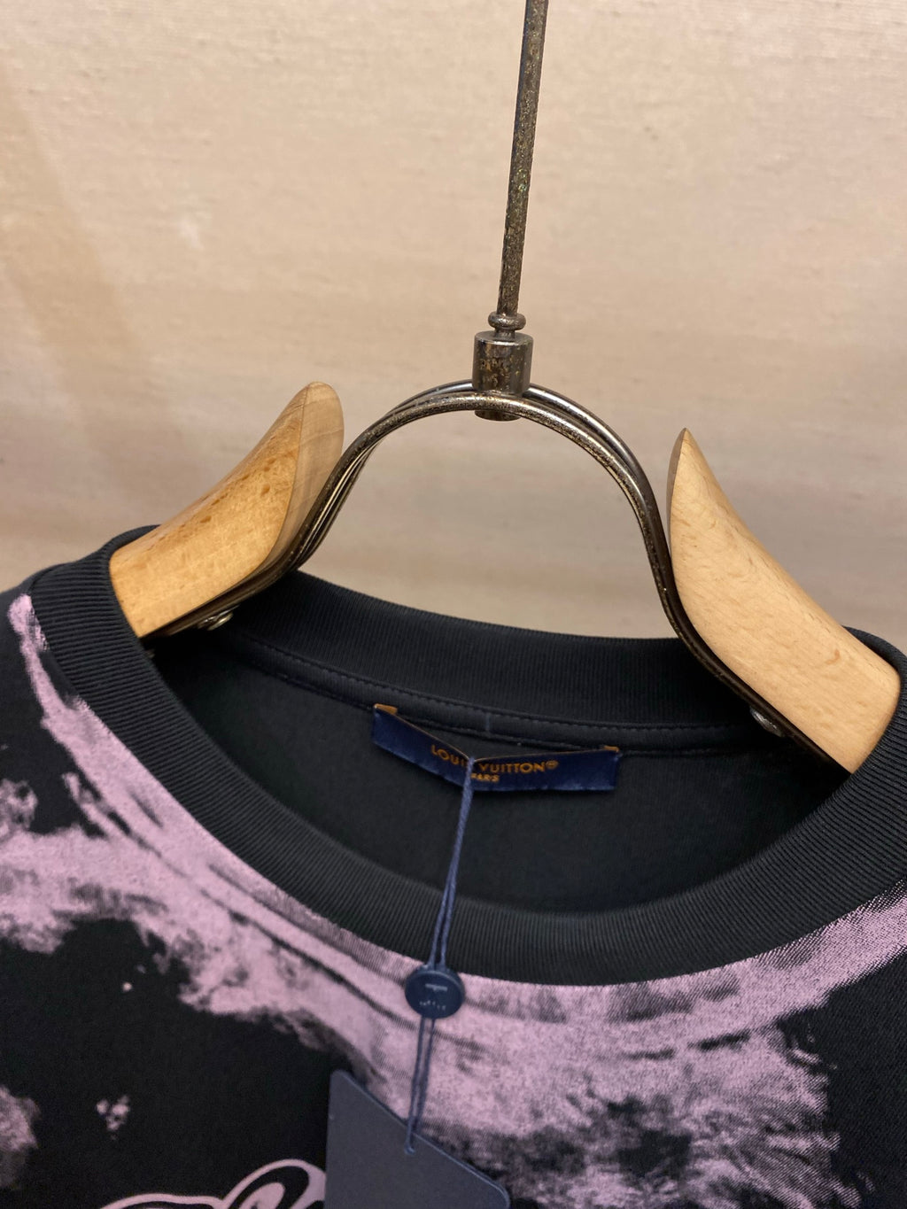 Crew neck graphic T-shirt collar in dark fabric with purple splatter detail
