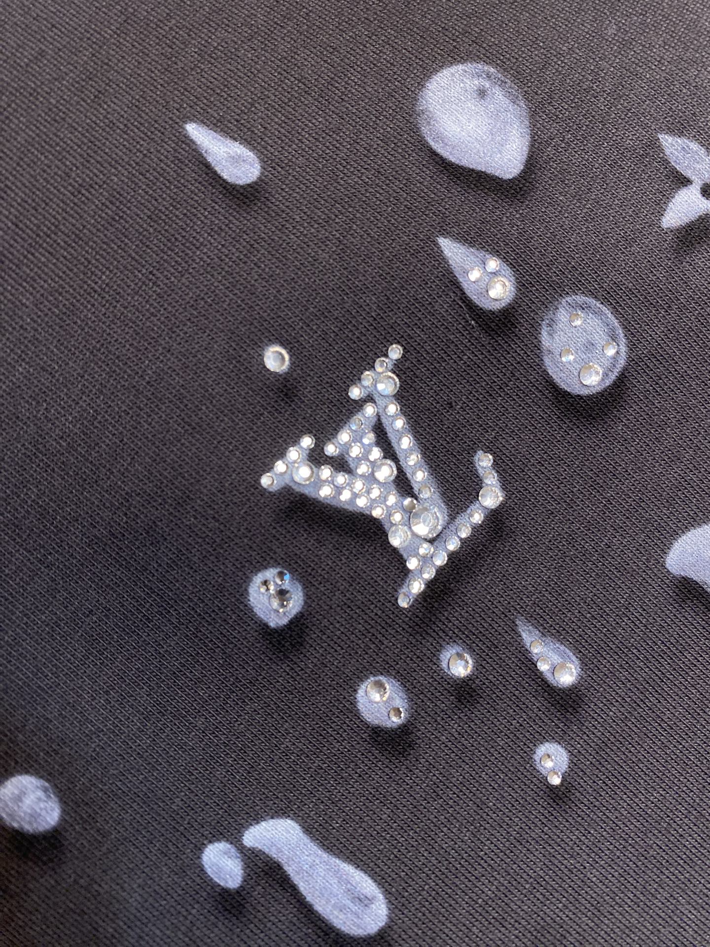 Louis Vuitton dark fabric with silver-like icon pattern, detail close-up