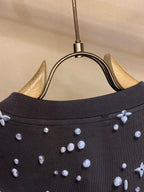 Louis Vuitton dark crew-neck collar with allover icon print, close-up on neckline