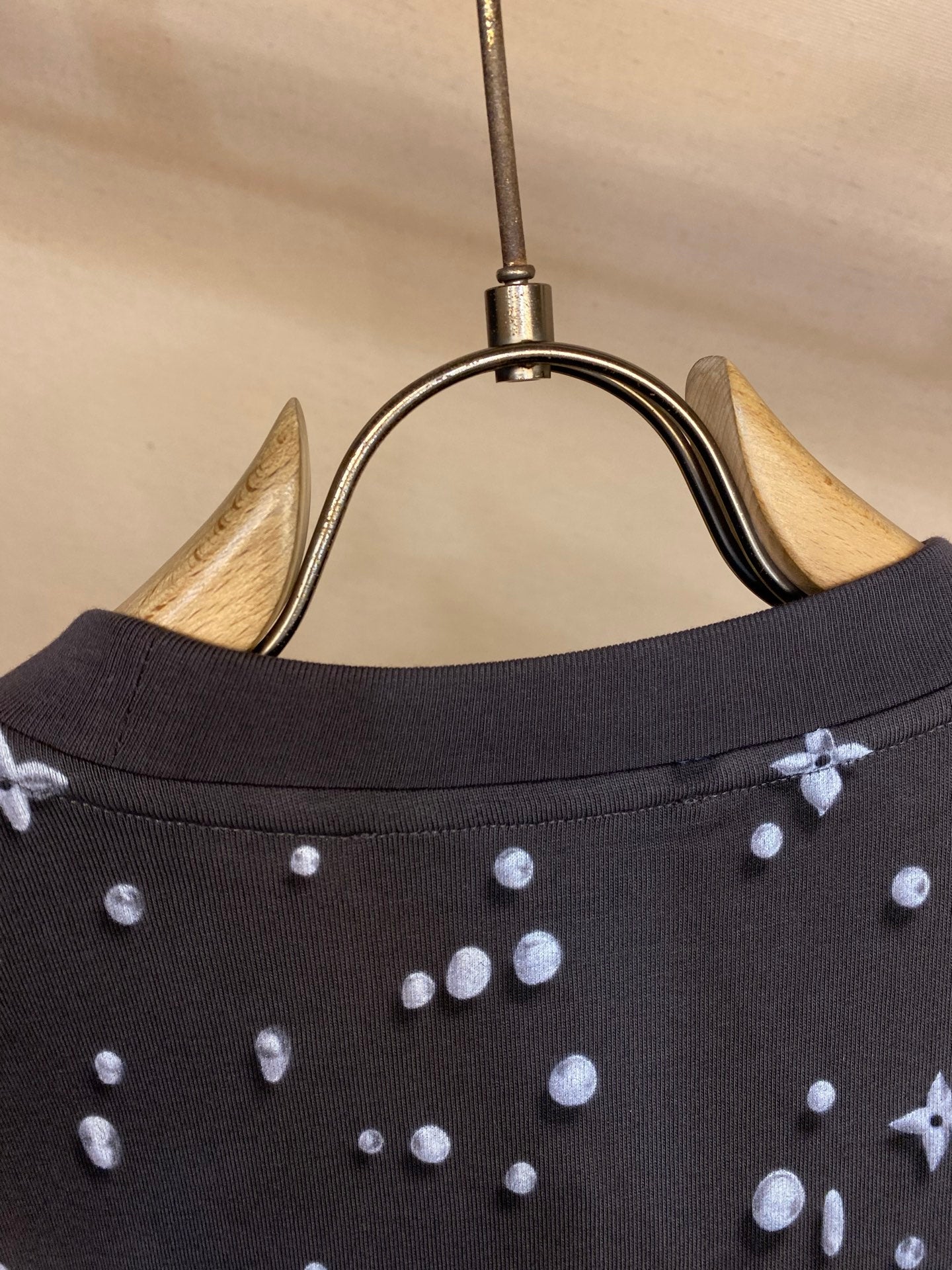 Louis Vuitton dark crew-neck collar with allover icon print, close-up on neckline