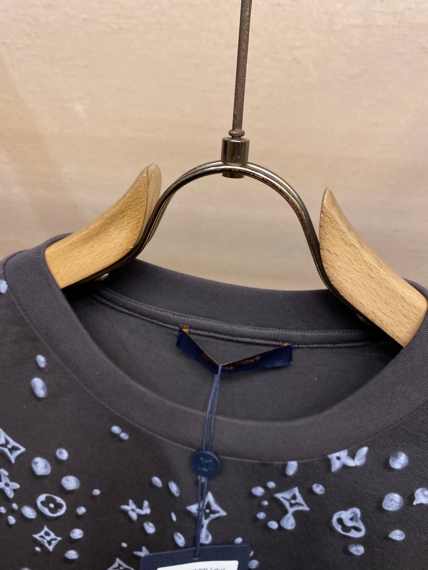 Louis Vuitton dark crew-neck T-shirt with allover logo print, close-up of neckline