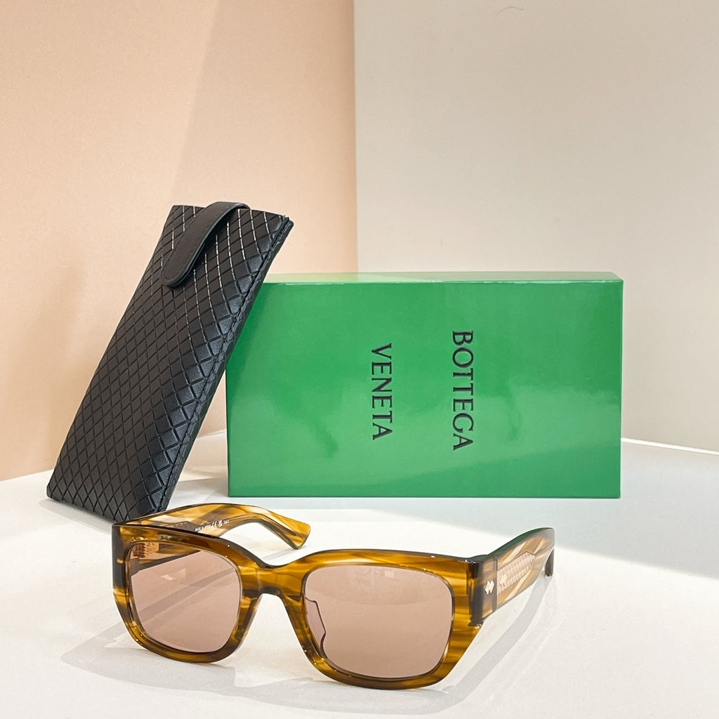 Amber tortoiseshell sunglasses with square lenses and gold-tone logo detail on frame
