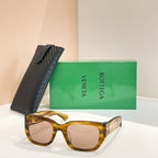 Amber tortoiseshell sunglasses with square lenses and gold-tone logo detail on frame