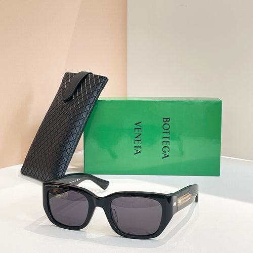 Dark tortoiseshell sunglasses with square lenses and gold-tone logo detail on frame