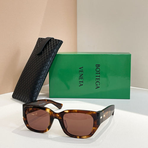 Brown tortoiseshell sunglasses with square lenses and gold-tone logo detail on frame