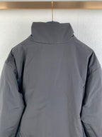 Dark gray hooded jacket back with high collar.