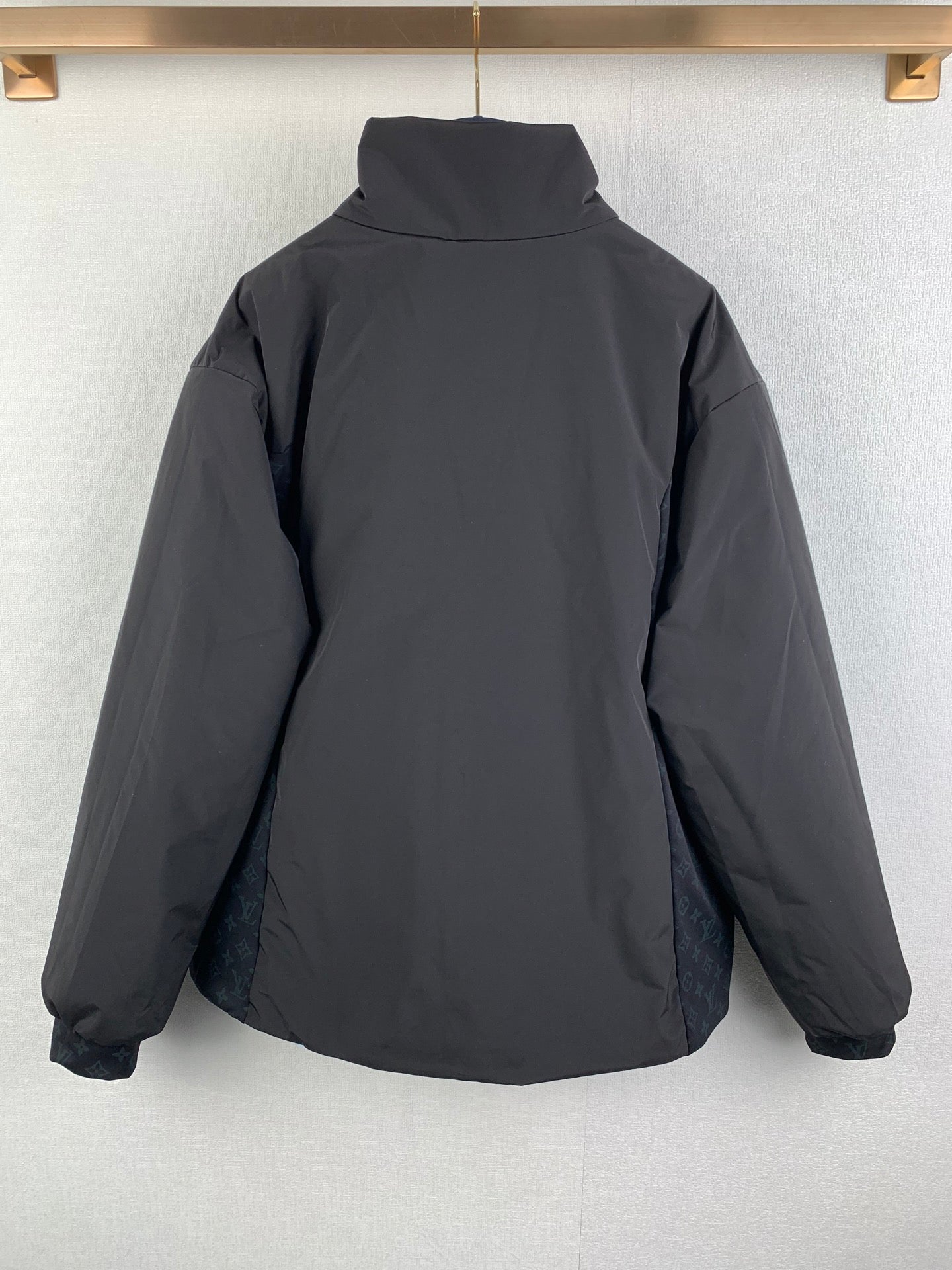 Dark gray hooded zip-up jacket back view, relaxed fit.