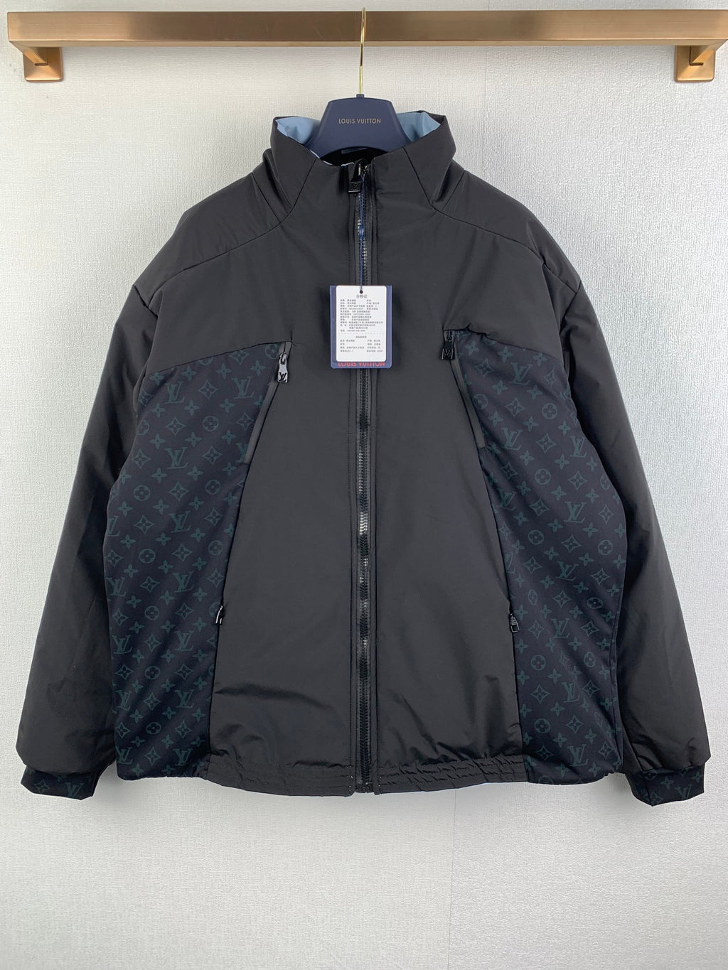 Dark gray hooded zip-up jacket with monogram panel, Louis Vuitton hang tag.