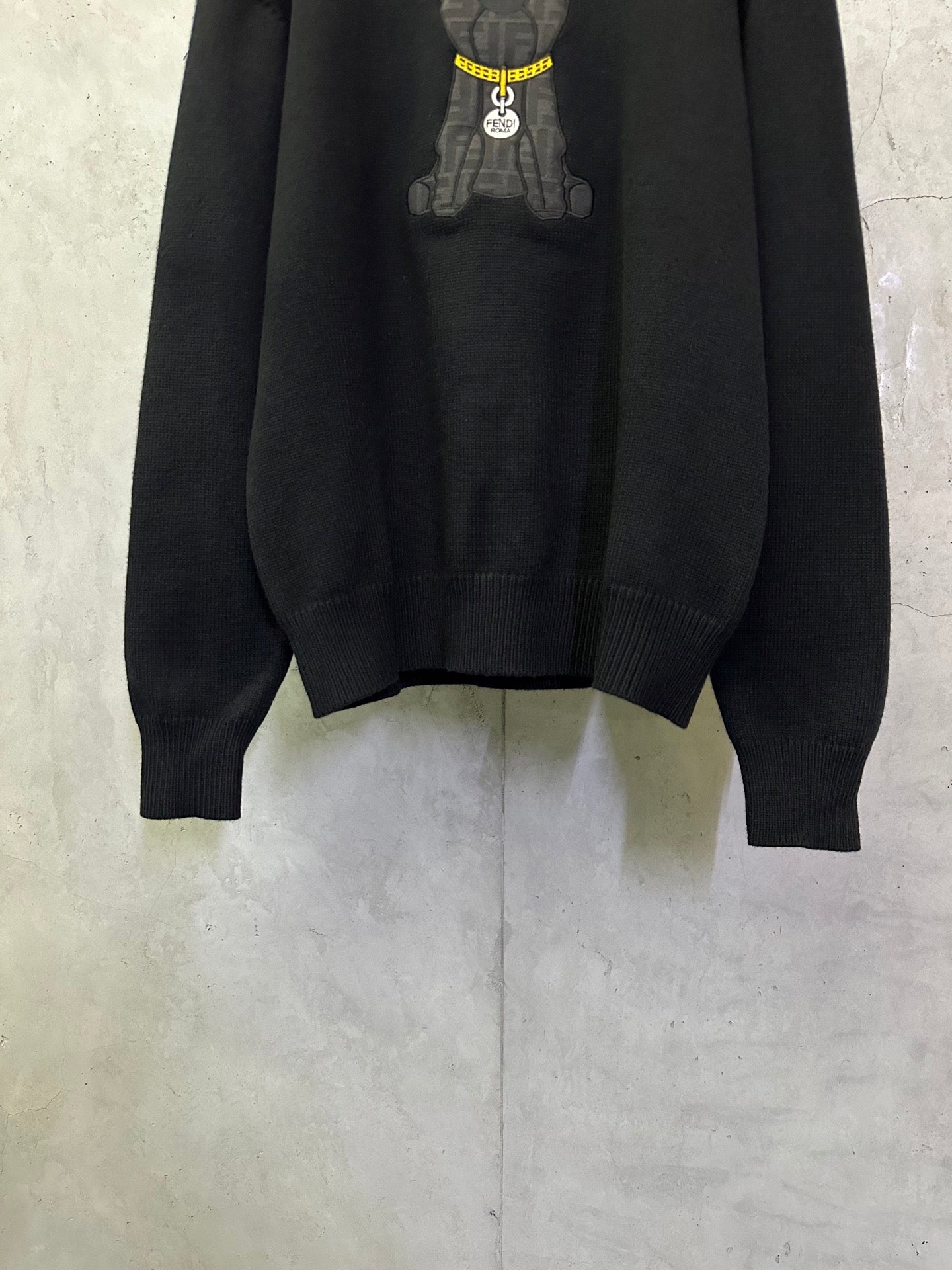 Fendi black knit sweater with ribbed cuffs and hem; bear graphic at top
