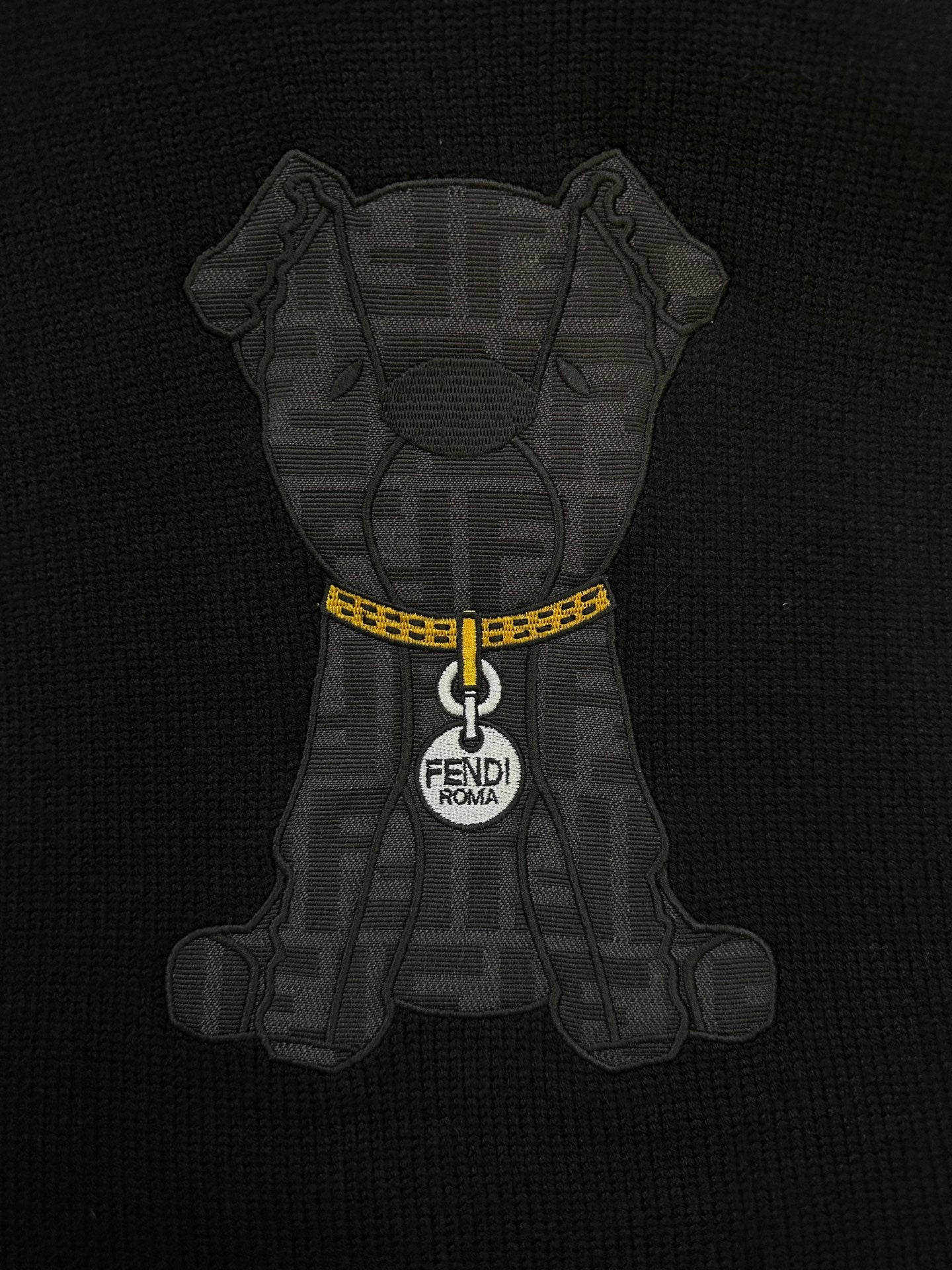 Fendi black sweater featuring gray bear graphic with yellow zipper and FENDI Roma tag