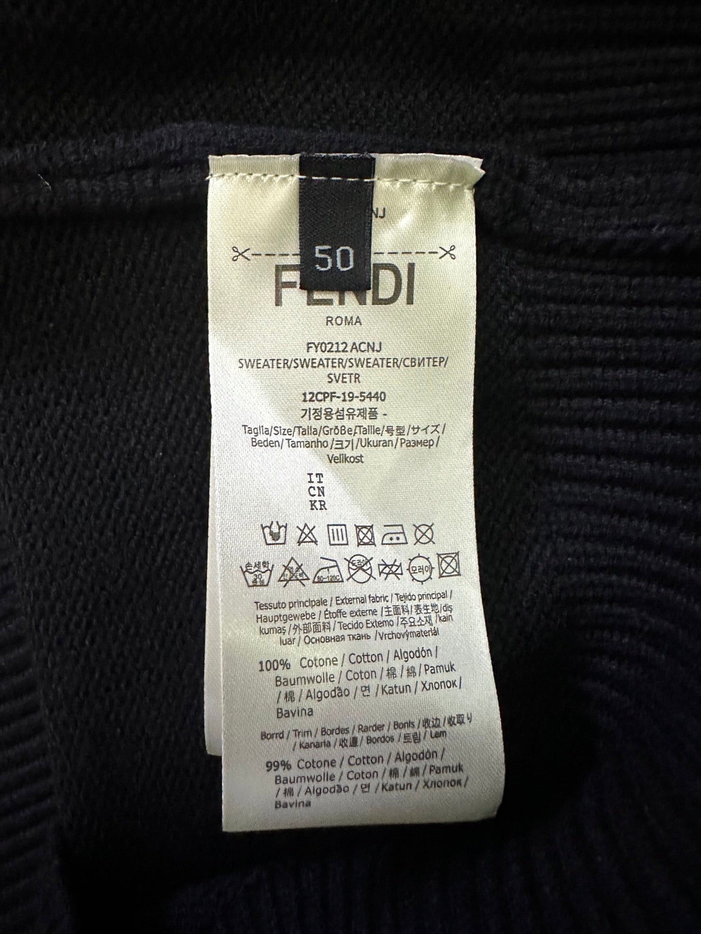 Fendi black knit sweater care label with size 50 and fabric content details