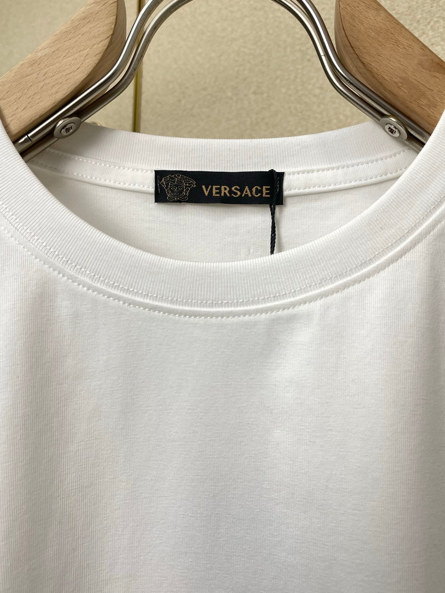 White crewneck T-shirt neckline with interior Versace label