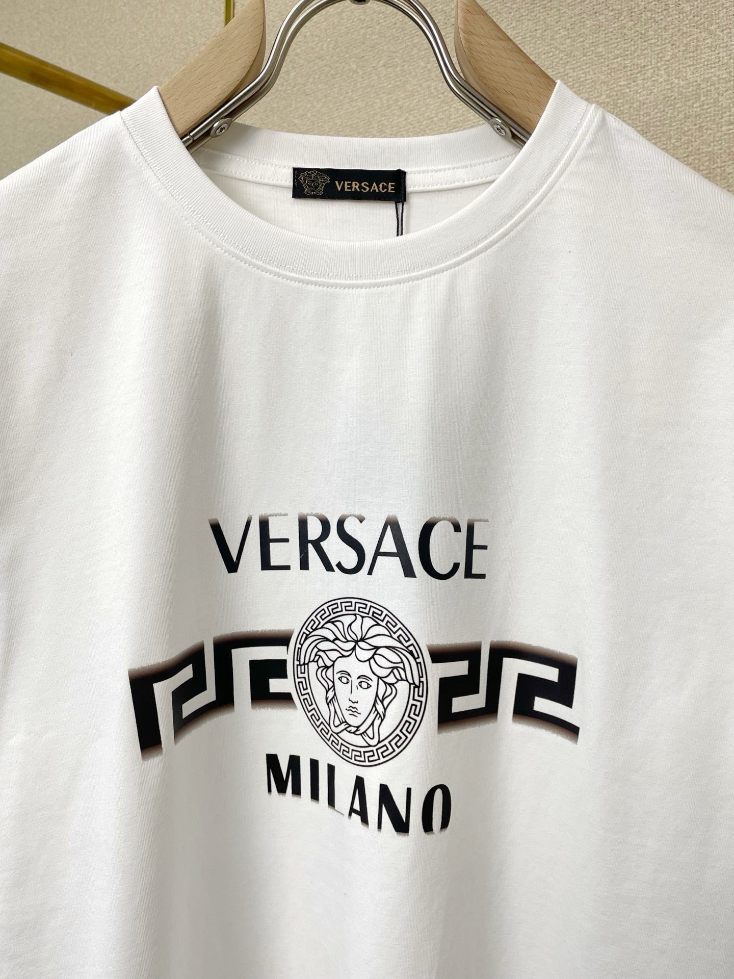 White short-sleeve T-shirt with crew neck and large Versace Milano logo print