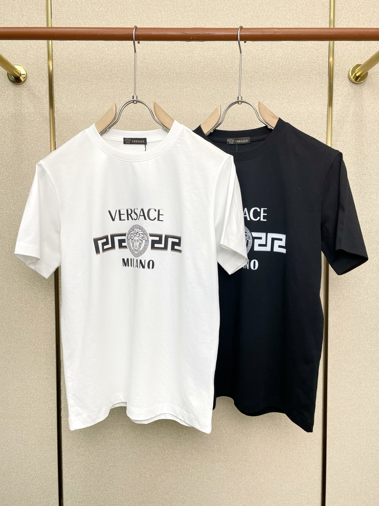 Short-sleeve T-shirts, one white and one dark, with Versace Milano logo print