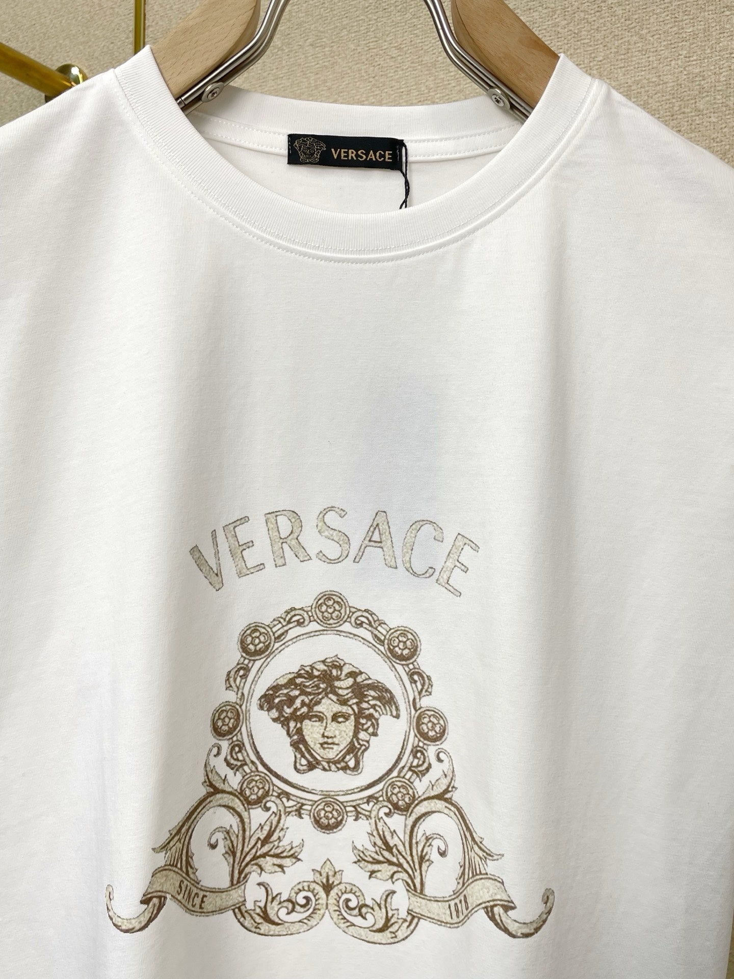 Versace white T-shirt close-up of VERSACE logo crest