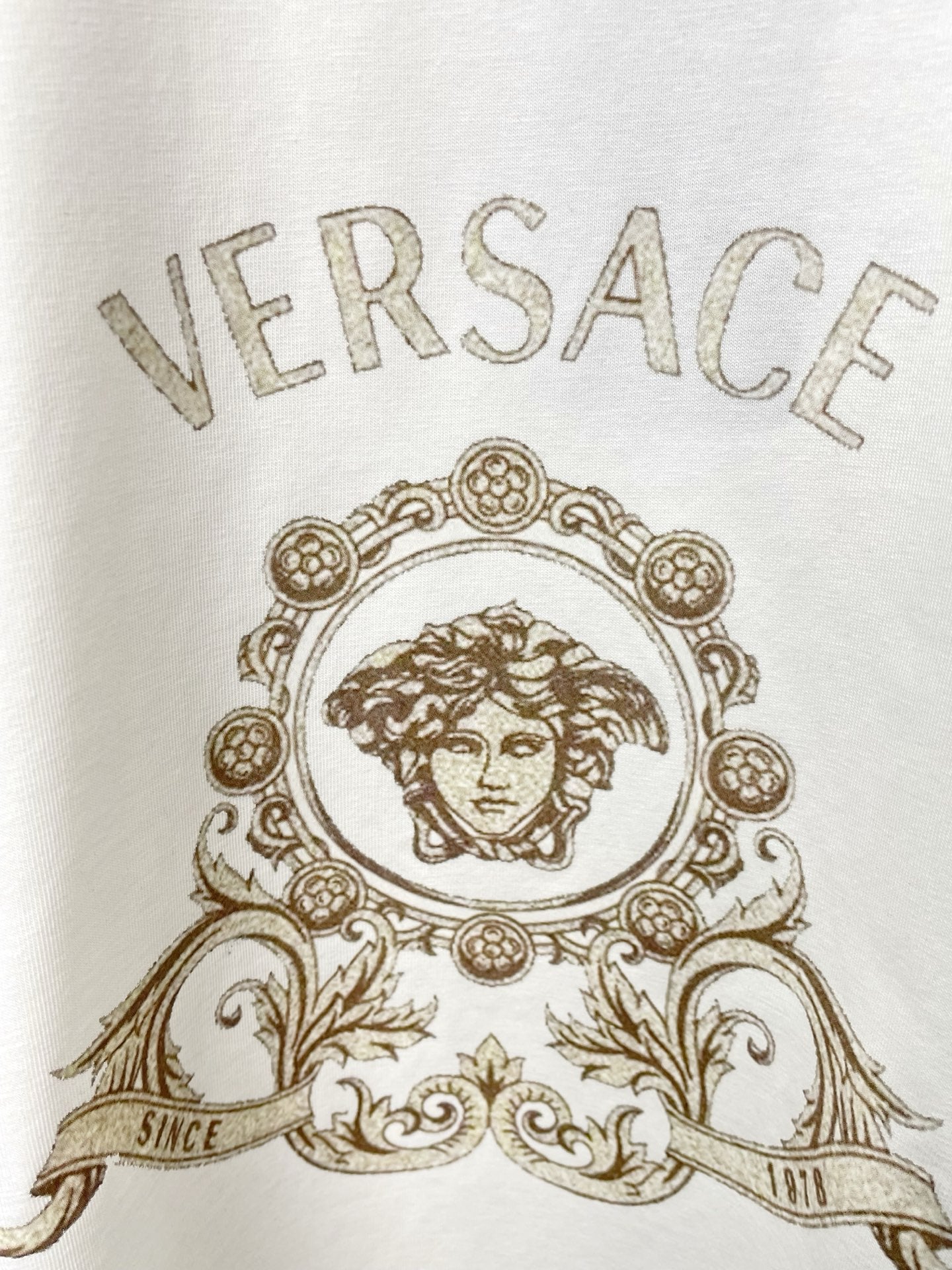 Versace white T-shirt close-up of crest portrait graphic