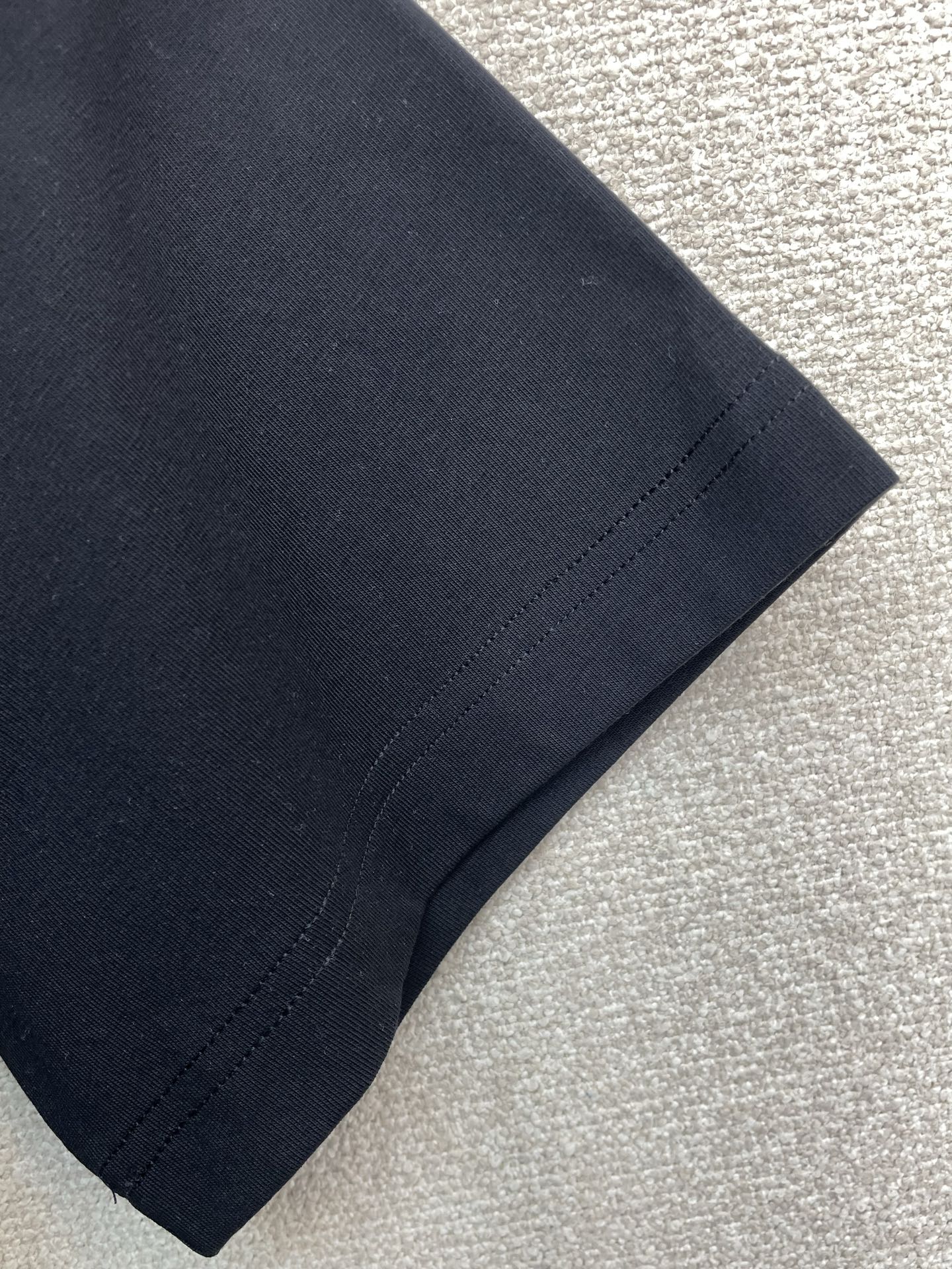 Versace black T-shirt sleeve and hem stitching detail