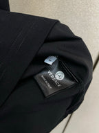 Versace T-shirt fabric tag reading VERSACE, Made in Italy