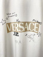 Versace white T-shirt chest graphic with stars, text, and VERSACE lettering