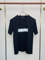 Navy Versace logo graphic T-shirt on hanger, crew neck, short sleeves.