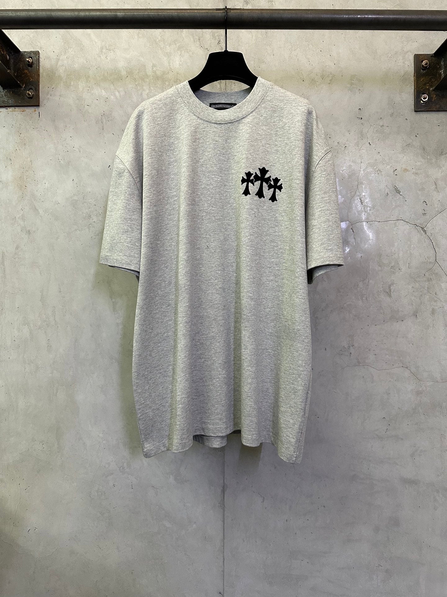 Light gray short-sleeve T-shirt with black cross logo on chest