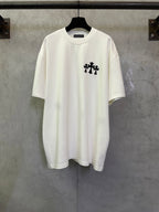 White short-sleeve T-shirt with small black graphic on left chest.