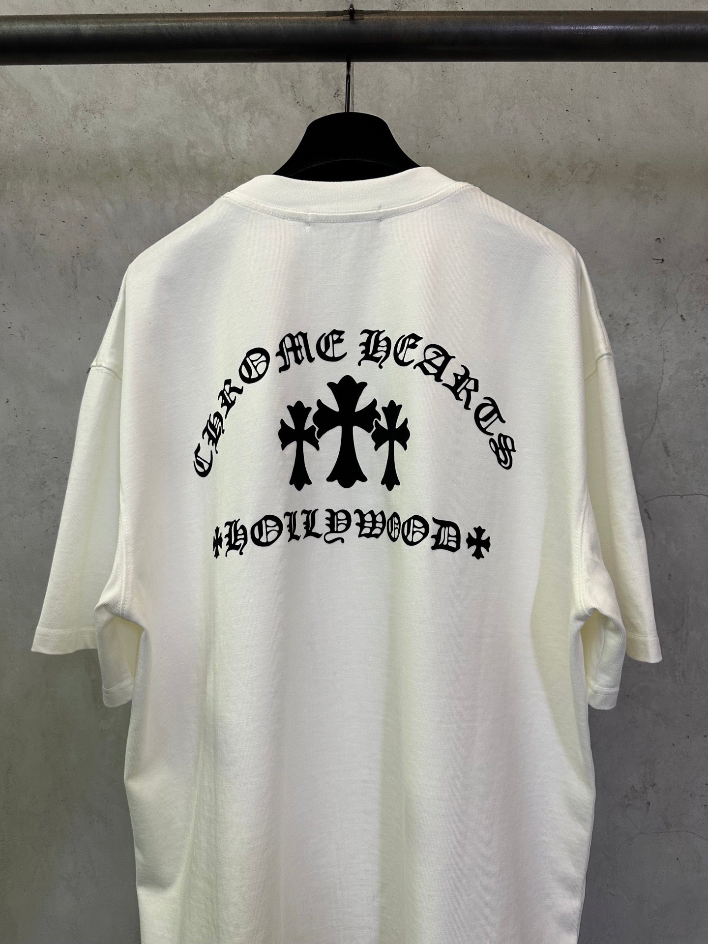 White short-sleeve T-shirt with large black back graphic and text.