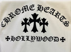 Black graphic lettering and three-symbol emblem on white T-shirt