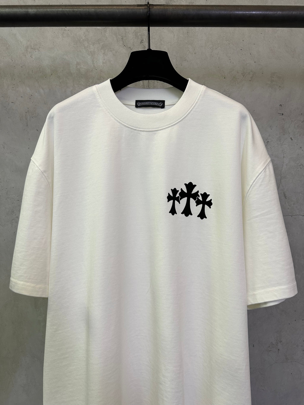 White crew-neck T-shirt with black chest logo graphic