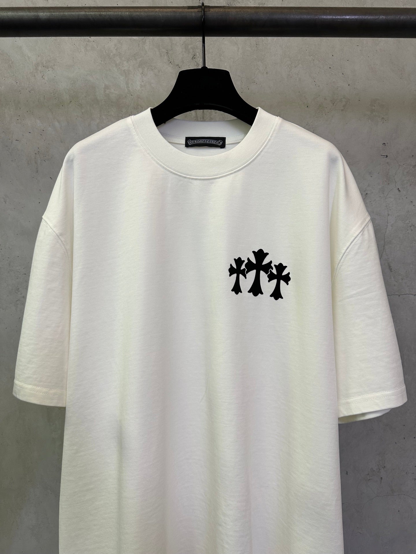 White crew-neck T-shirt with black chest logo graphic