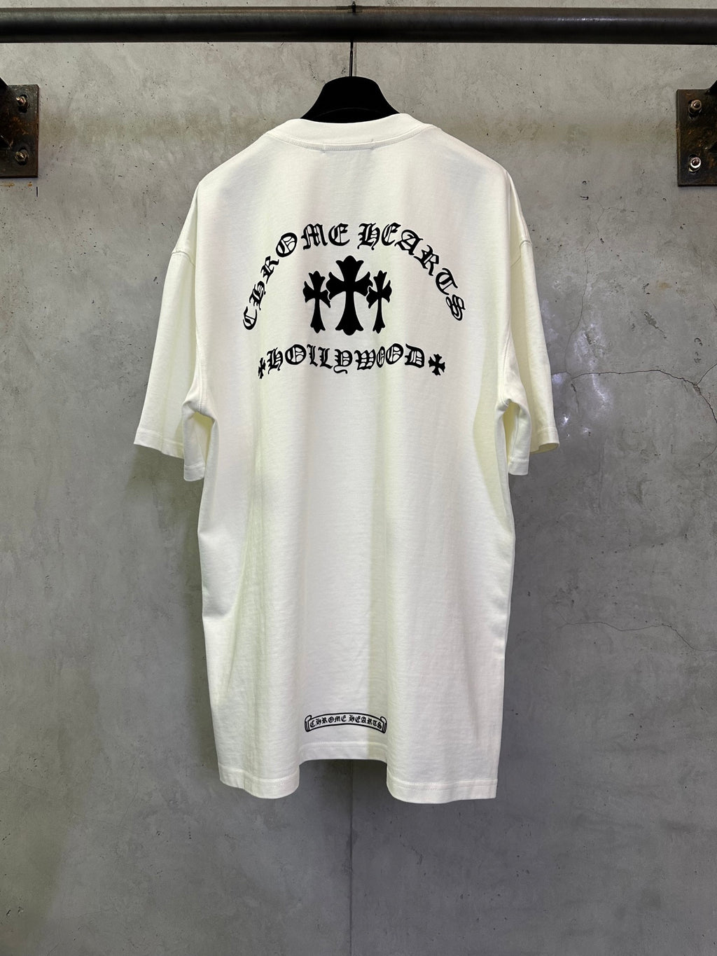 White crew-neck T-shirt with large black back graphic lettering and symbols