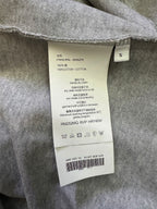 Heather gray T-shirt care label with size and fabric details