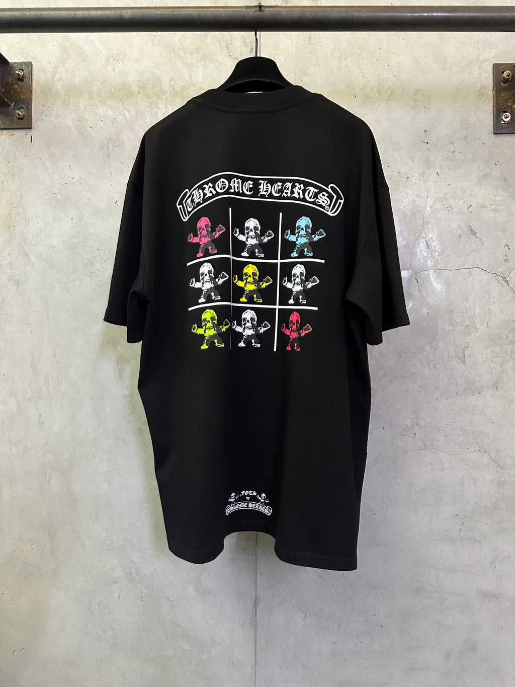 Black crewneck T-shirt with colorful 'Chrome Hearts' skeleton grid graphic