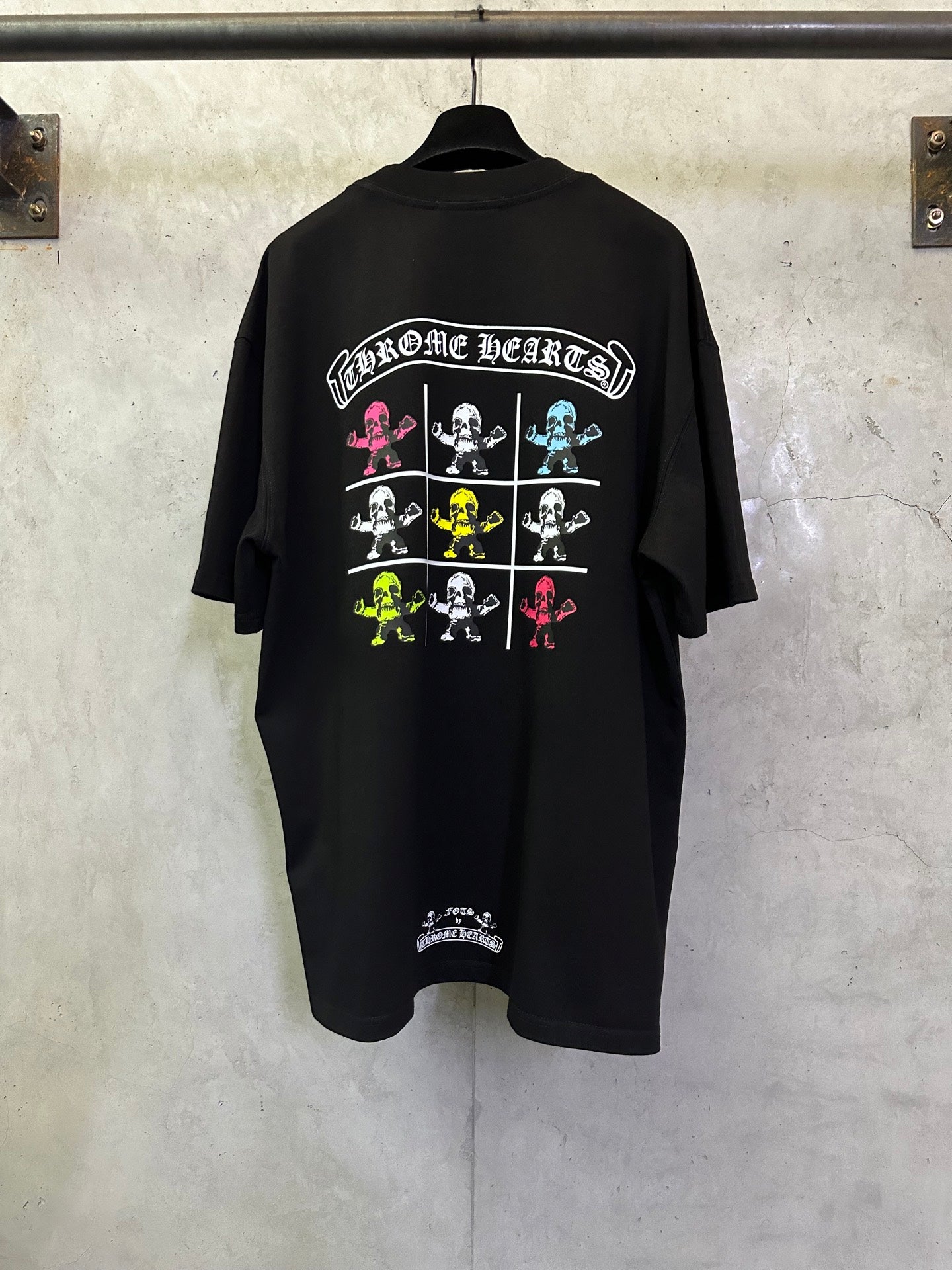Black crewneck T-shirt with colorful 'Chrome Hearts' skeleton grid graphic