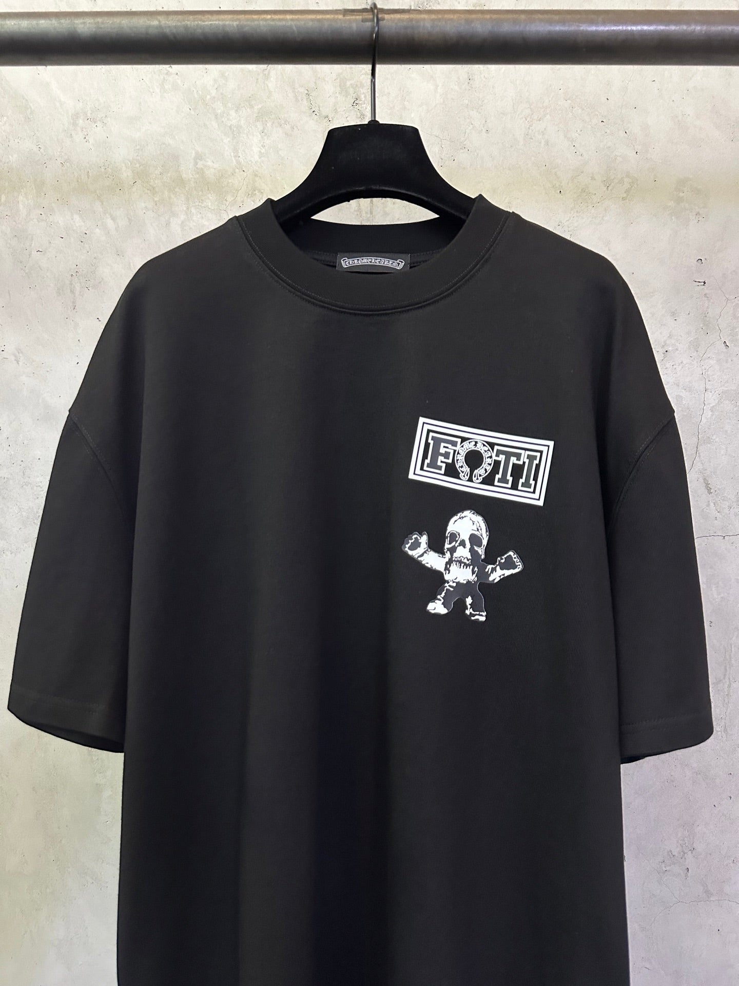 Black crewneck T-shirt with 'FOTTI' crest logo and skull graphic