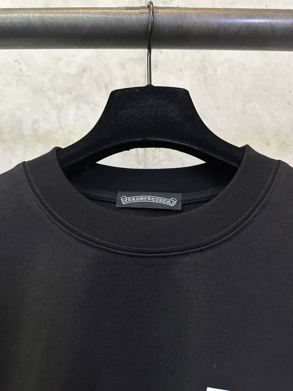 Black crewneck T-shirt with ribbed collar and small brand tag