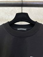 Black crewneck T-shirt with ribbed collar and small brand tag
