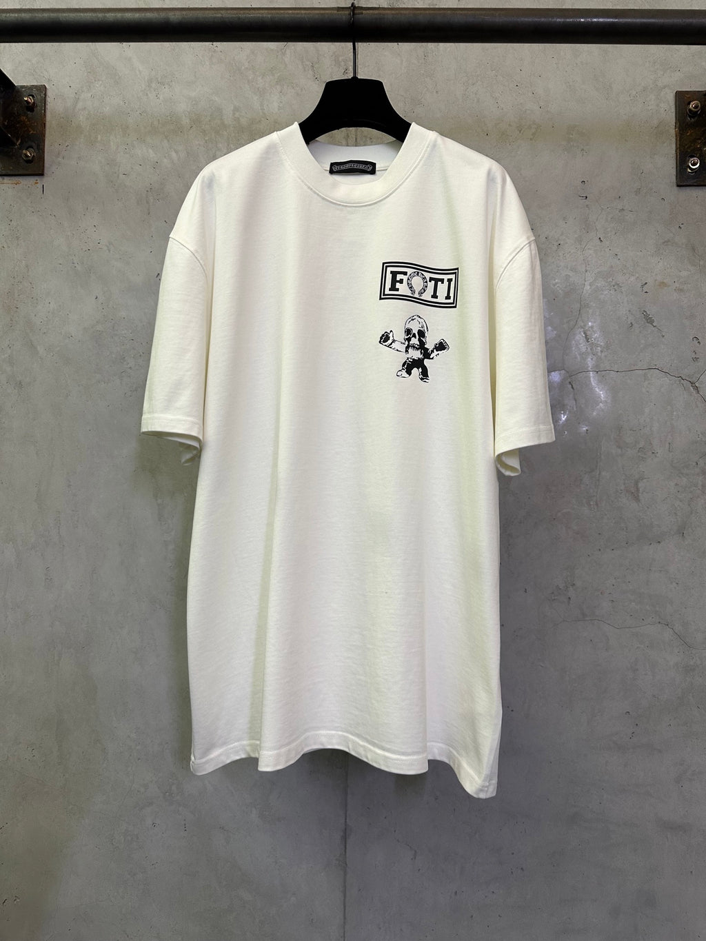 Light short-sleeve T-shirt with FOTI logo and cartoon figure graphic on chest