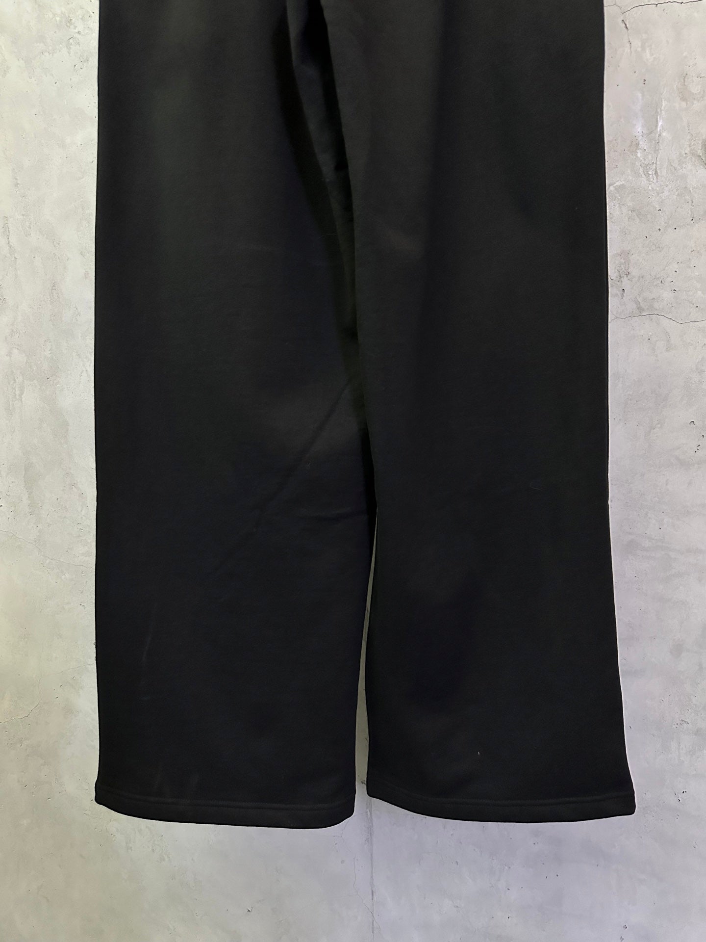 Black Balenciaga track pants with elastic waistband and wide leg openings