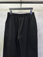 Black Balenciaga track pants with elastic waistband and relaxed straight legs