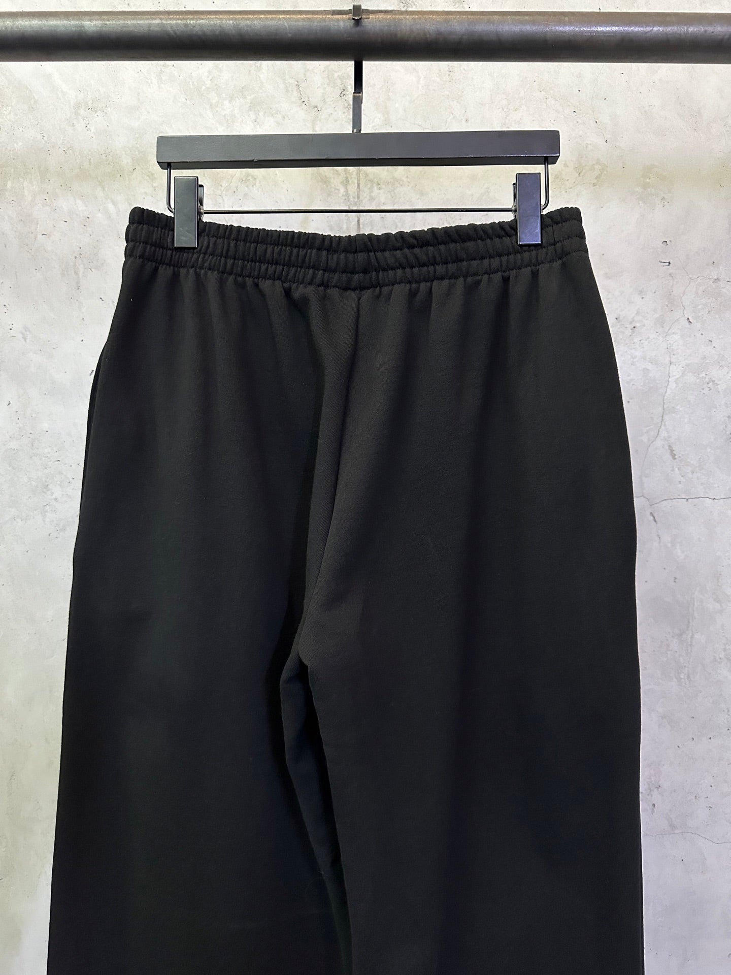 Black Balenciaga track pants with elastic waistband and relaxed straight legs