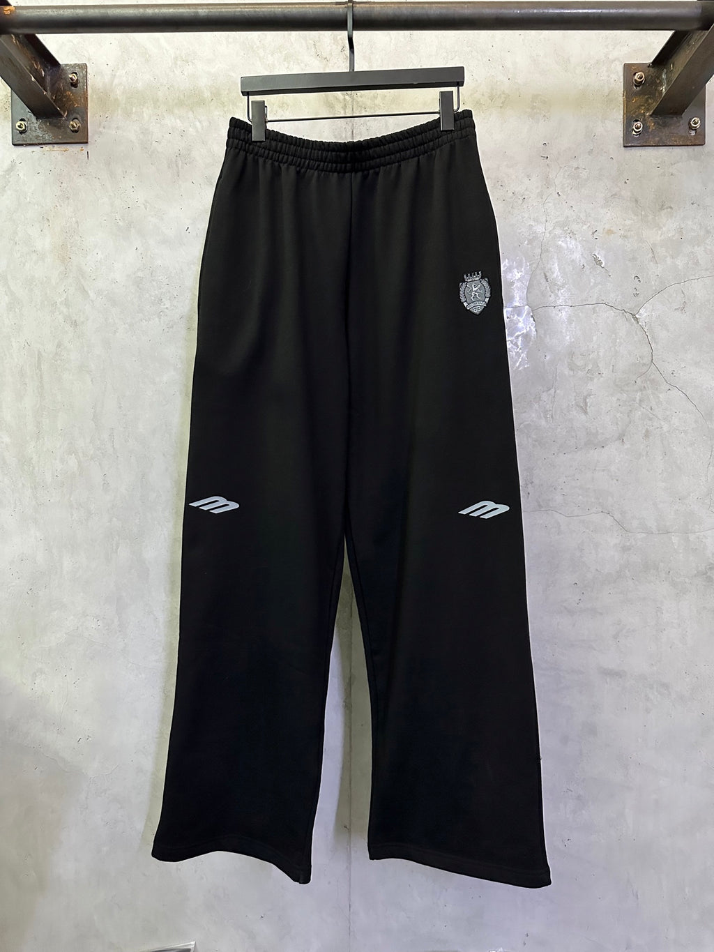 Black Balenciaga track pants, elastic waistband, wide legs, white logo accents