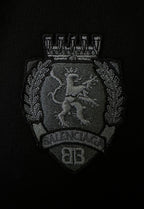 Black fabric patch with Balenciaga crest emblem in gray thread