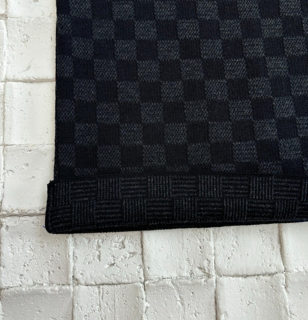 Louis Vuitton checkered knit polo hem edge on dark textured fabric